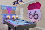 The room features a fun Cars theme complete with custom artwork and a pool table